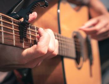 close up of someone playing guitar