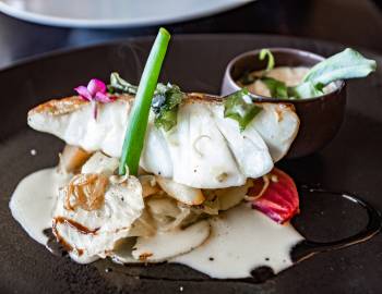 Platter of fresh cod cooked fish