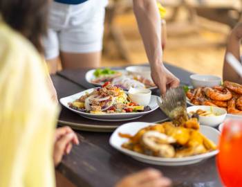people eating at outdoor restaurant near beach
