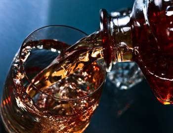 Whiskey pouring into a glass. View from above