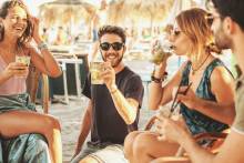 friends at a beach bar happy hour