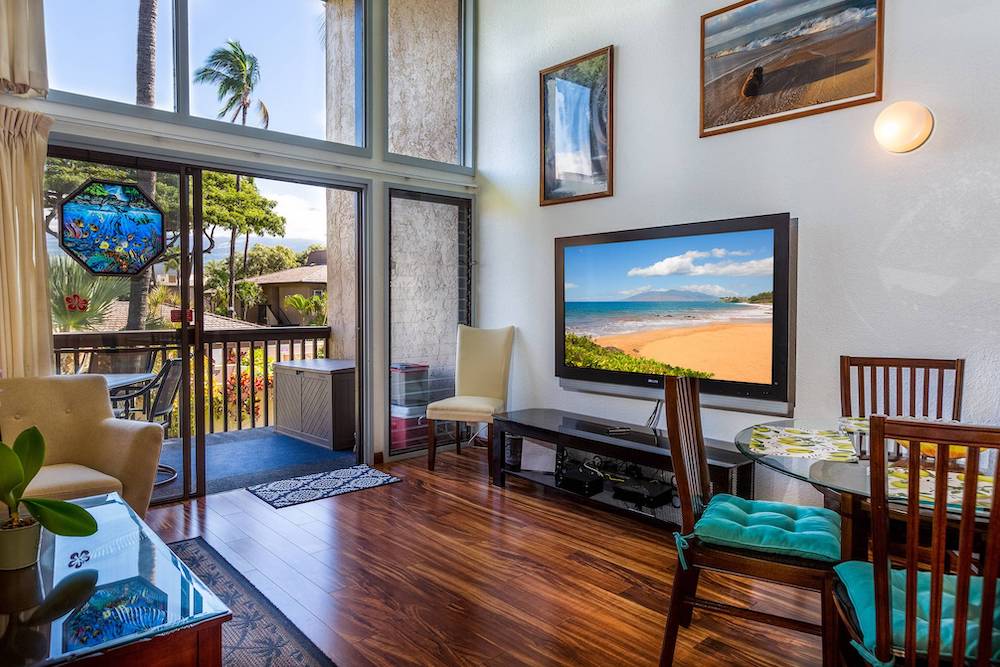 interior of maui condo with floor to ceiling windows and arched ceiling
