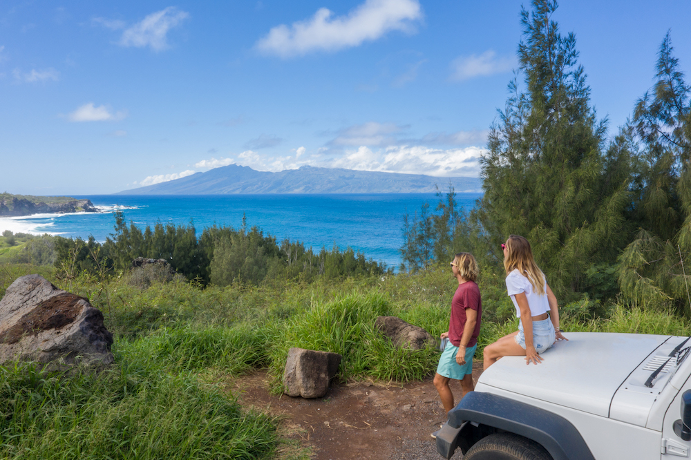 couple overlooking ocean from mountain drive on Maui